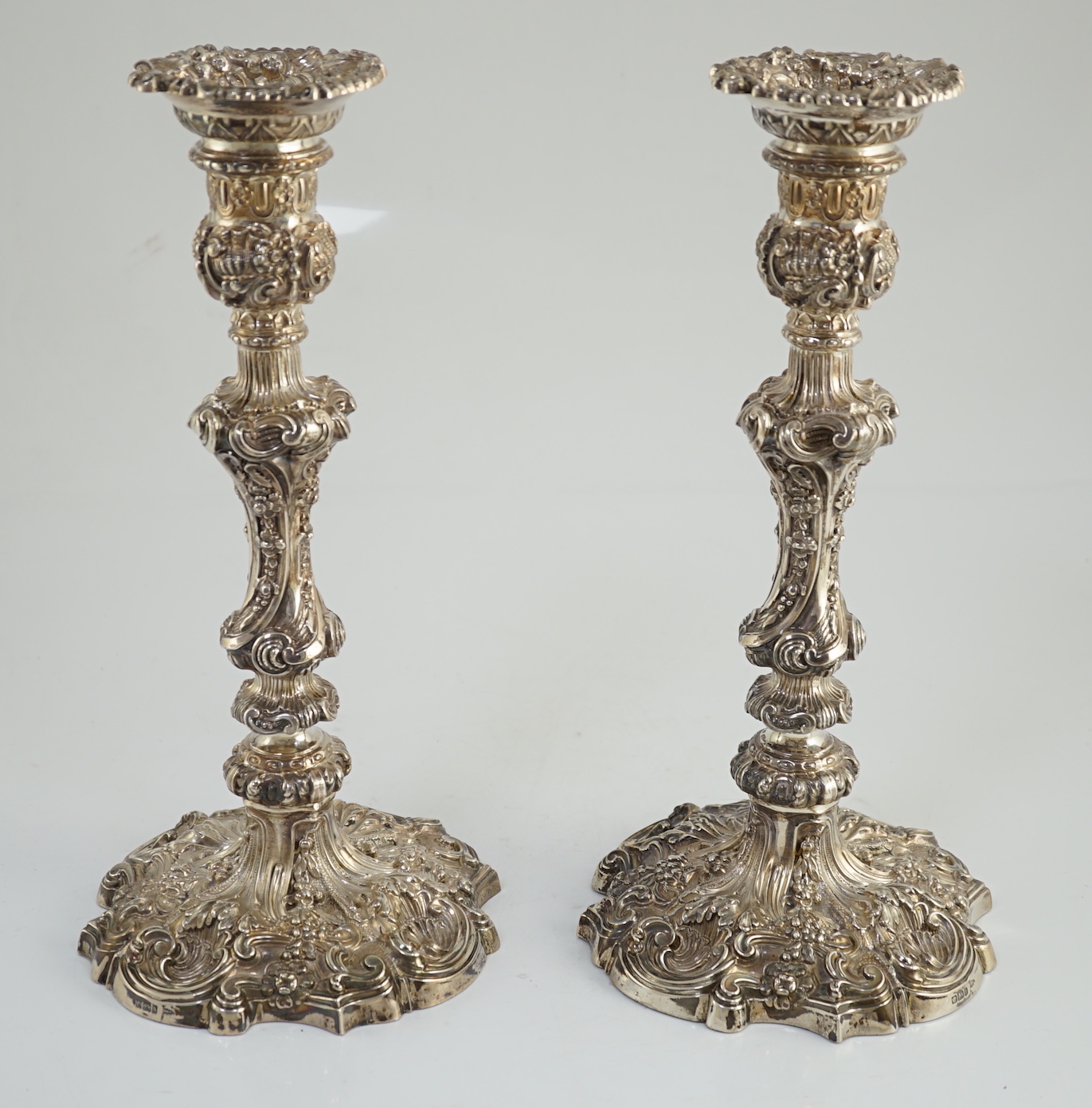 An ornate pair of Edwardian silver candlesticks, by Walker & Hall